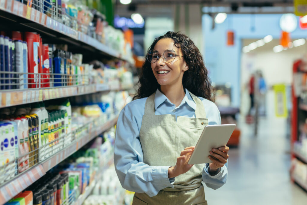 young hispanic woman works supermarket stands uniform department household